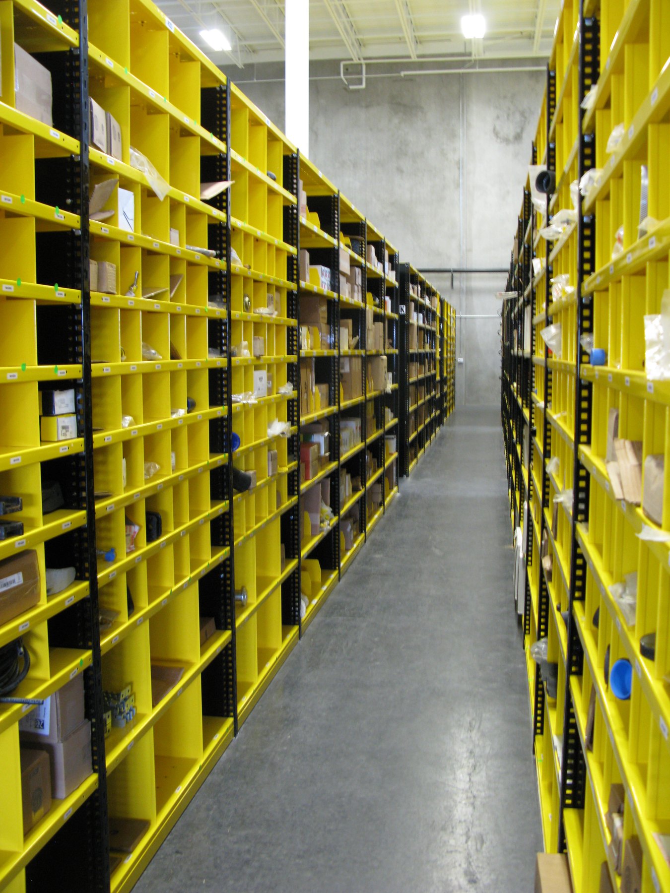 John Deere yellow parts shelving aisle